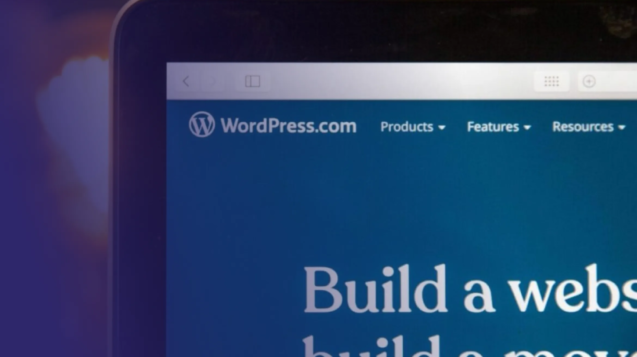 laptop screen shows wordpress.com